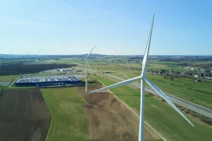 Photo by Johny Goerend white wind turbine on green grass field during daytime